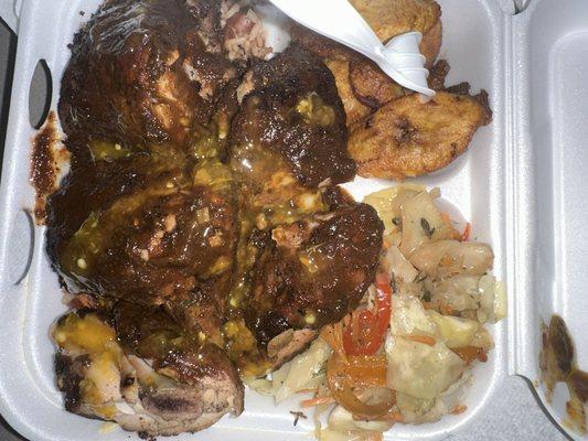 Jerk chicken combo over red beans and rice with seasoned cabbage and plantains