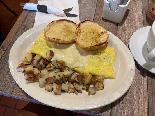 Western omelet with provolone cheese, home fries and croissant.