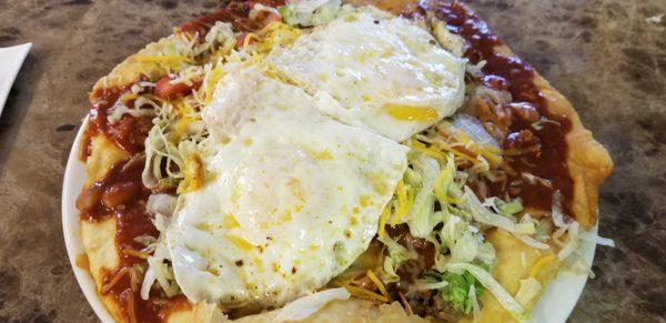 Indian Taco with two eggs over easy. Red chile sauce. May I add it was incredibly delicious!