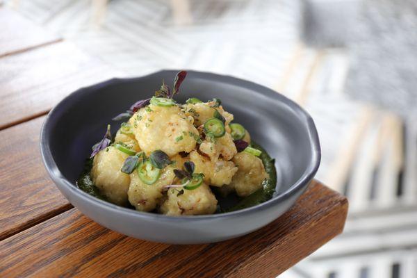 Cauliflower Tempura made with aji panca aioli, salsa verde, sliced serrano, chives