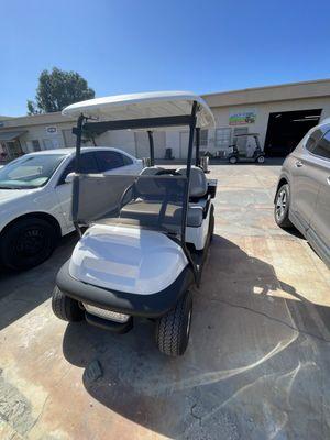 Custom white golf cart made by California Golf Cars