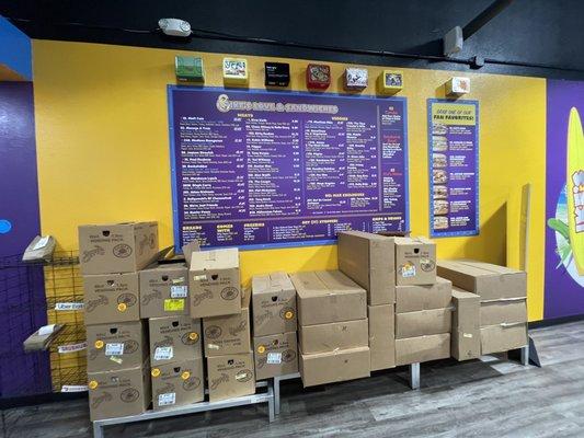 The storage racks filled with boxes are right smack in the middle of the store underneath the menu board.