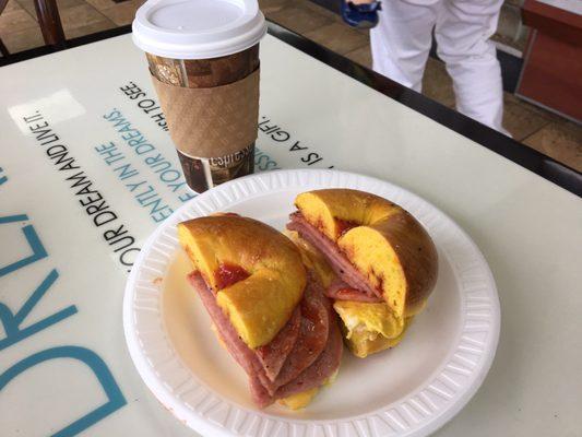 Porkroll egg and cheese on an egg bagel