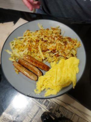 Hash browns, pork sausage links and scrambled eggs.