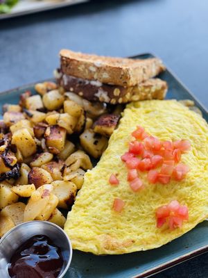 The Works (Omelet) with potatoes on the side.