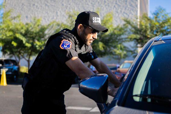 Wolfpack Protective Services guard assisting authorized personnel