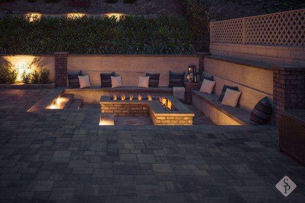 L-shape sunken fire pit with custom outdoor LED lighting design.