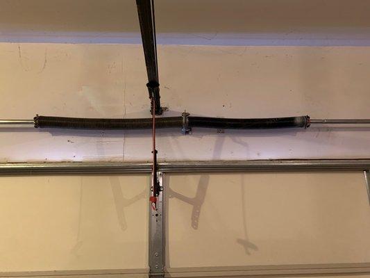 Left garage door spring installed by Herdon obviously does not match spring on right side.