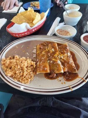 Beef enchilada dinner with rice and beans.