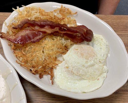 Perfect over easy eggs delicious crispy hash browns & bacon