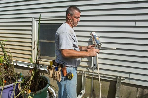 Heat Pump Installation - foaming holes inside the wall cavity where lineset enters the house.