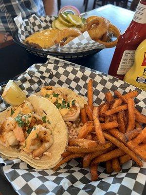 Cheeseburger on brioche bun and blackened shrimp tacos with cinnamon spiced sweet potato fries.