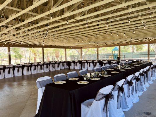 Horseshoe table and chair setting. Linens, chair covers with bows.