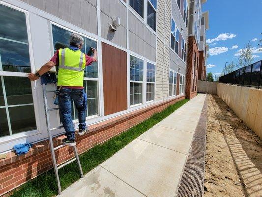 Professional window washing at opening apartment complex in MD