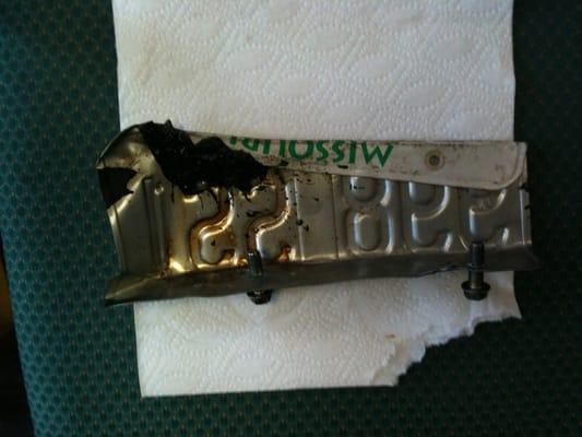 The license plate after removal from under the engine.