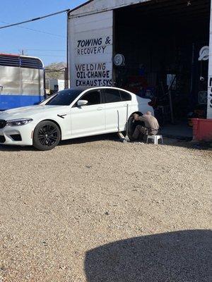 Owner of the shop repairing my tire