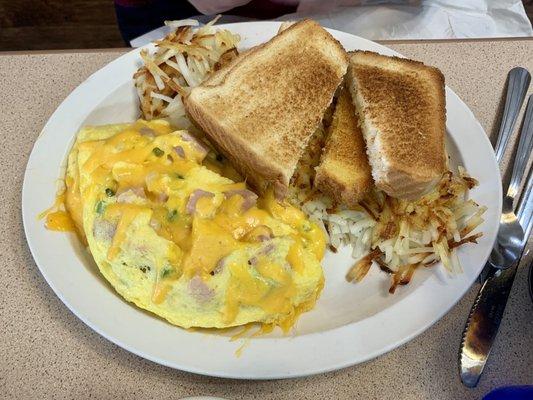 Denver omelette with hash Browns and white toast.