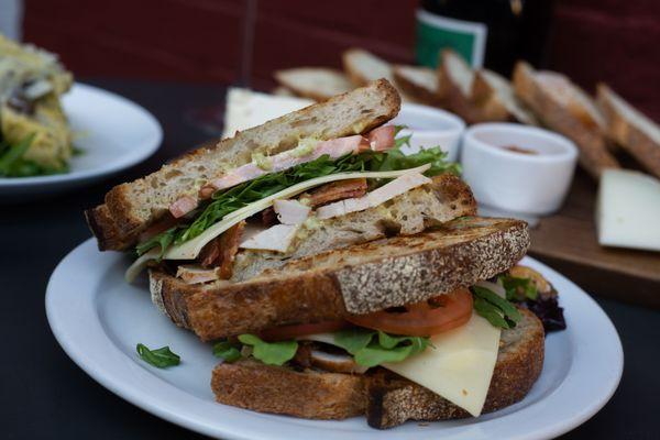 Koch's Smoked Turkey Sandwich with Cabot Cheddar, North Country Bacon, Tomato, Arugula and Truffle-Herb Aioli