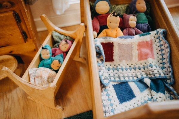 Natural materials and handmade dolls are some of our favorite nursery toys!