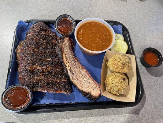 Half a rack of ribs and brisket, boudin balls, and baked beans