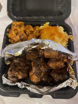 Oxtails with sides of Macaroni and Cheese Candied Yams