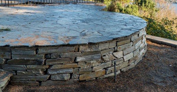 upper flagstone veneer patio and stack stone walls