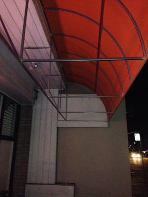 Overhead bars for back-walking under awning in front of shop.