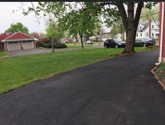 Top of driveway tight area between tree and house.