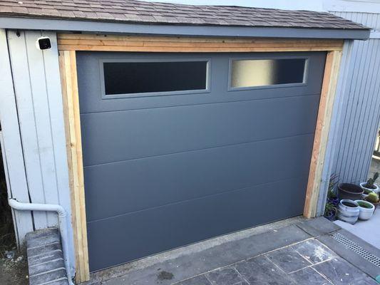 Installed an Flush Panel collection garage door in gray color and obscure glass.