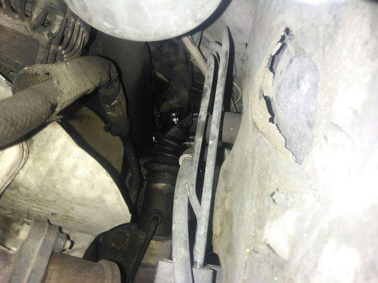 View from above of the torn and twisted c.v. boot on passenger side.