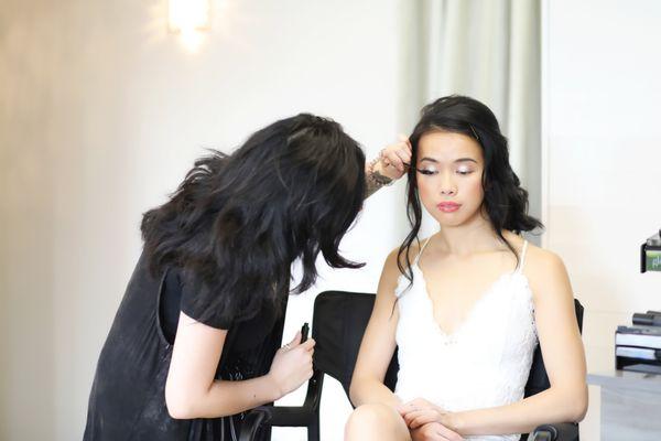 Makeup artist working on a bridal look