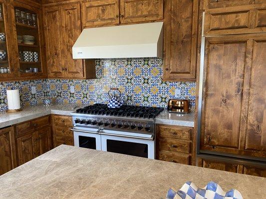 TAJ MAHAL kitchen countertops with a tile backsplash 

Professionally installed by the Serrano Team