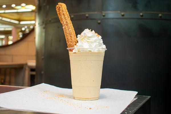 Delicious shakes with a churro for dessert after eating tasty Mexican food.