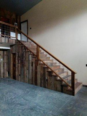 Staircase finished in barn wood cladding.