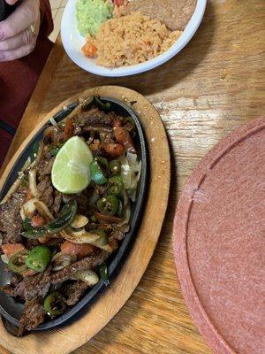 Poblano beef fajitas rice and beans. Meat way overcooked.