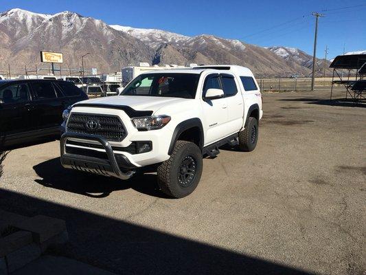 Front angle view of an M.X. Series on a new short bed Tacoma