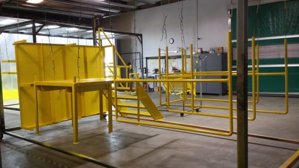 Platform and scaffolding fabricated and powder coated in Safety Yellow by CalHot  at Northern California Injection Molding, Rancho Cordova.