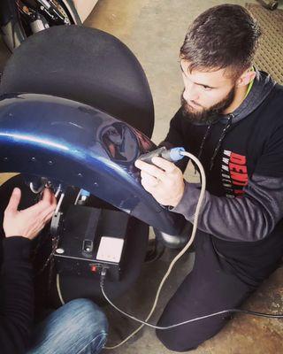 Our tech repairing motorcycle fender!