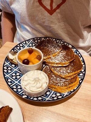 Pumpkin pancakes with fruit cup and whipped cream