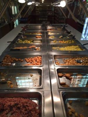 Wide variety of hot bar breakfast items. Different types of eggs, potatoes, meat sides, French toast, biscuits, etc.