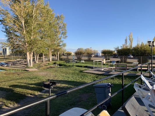 Grassy area with seating and games.