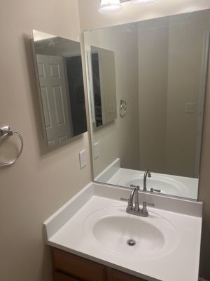 Installing new sink and accessories valves, mirror, and wall cabinet.