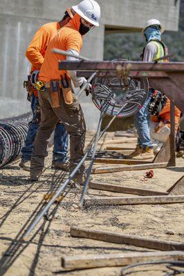 Crew tying rebar cages