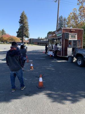 Properly distanced line waiting on delicious food!