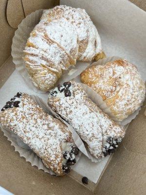 Cannolis and mini lobster tail pastries with French cream filling.