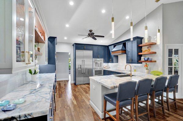 This kitchen remodel in Davie, Florida is a blue lovers' dream, accented perfectly with white backsplashes and gold detailing.