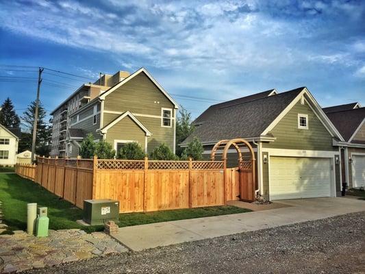 Privacy fence with lattice and arbor.