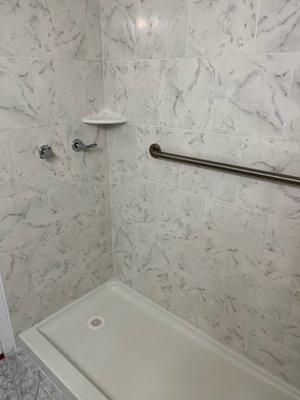 Easy access shower with 5' pan and grab bars.