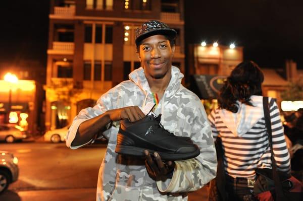 A young man at our Youth Outreach Van shows off the new shoes he received.