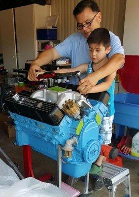 Carlos & son working on a 440 Mopar big block